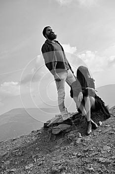 Summer vacation in the mountains. Young couple observe mountain scene