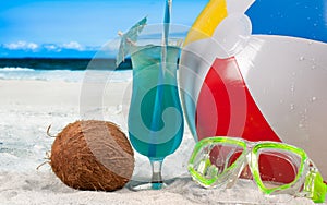 Summer vacation on seaside. Color ball, cocktails and mask on beach