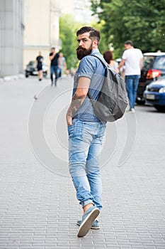 Summer vacation. Sightseeing concept. Backpack for urban travelling. Hipster wearing backpack urban street background