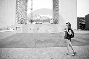 Summer vacation. Sightseeing guide. Girl tourist sunglasses enjoy city center square. Woman stand in front of urban