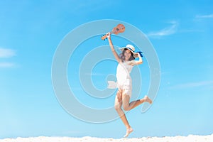 Summer Vacation. Smelling asian women relaxing and jumping with ukulele on the beach, so happy and luxury in holiday summer,