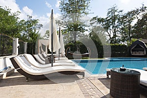 Summer vacation. Swimming pool of luxury hotel with umbrella and chair around. Hotel resort in Bulgaria, Primorsko for travel photo