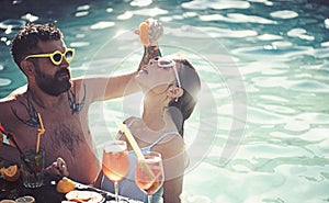 Summer vacation and swimming at sea. couple of bearded man and woman with cocktail and fruit in miami. Cocktail at man