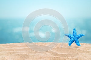 Tropical beautiful seascape view of sand beach with star fish and blurred blue sky with bokeh sunlight in background.