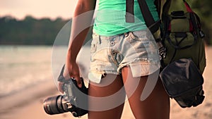 Summer vacation, travel and lifestyle concept: carefree woman with camera enjoy sunset over tropical beach