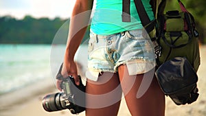 Summer vacation, travel and lifestyle concept: carefree woman with camera enjoy sunset over tropical beach