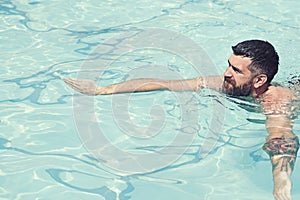 Summer vacation and travel to ocean. bearded man swimming in blue water. Relax in spa swimming pool, refreshment and