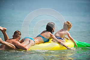 Summer vacation and travel to ocean. Happy family couple on Caribbean sea. Father and mother with son play in water