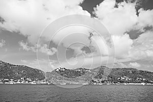 Summer vacation on tropical island. Mountain shore in blue sea on cloudy sky in gustavia, st.barts. Wild nature and