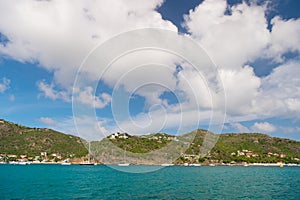 Summer vacation on tropical island. Mountain shore in blue sea on cloudy sky in gustavia, st.barts. Wild nature and environment, e