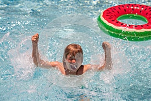 Summer vacation on tropical sea water. Child boy swim in summer swimming pool.