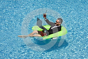 Summer vacations and freedom travel concept. Portrait of hispanic business man on the beach. Businessman in suit