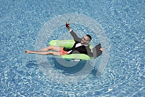 Summer vacations and freedom travel concept. Portrait of hispanic business man on the beach. Businessman in suit