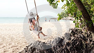 Summer Vacations. Lifestyle women relaxing and enjoying swing on the sand beach,