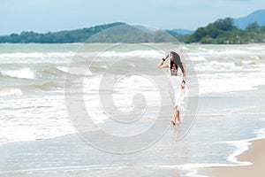 Summer Vacations. Lifestyle women relaxing and enjoying swing on the sand beach, fashion stunning women with white dress on the tr