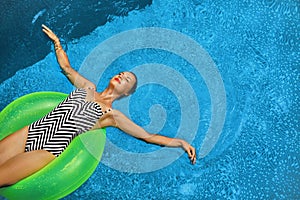 Summer Vacations. Woman Sunbathing, Floating In Swimming Pool Water