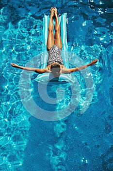 Summer Vacations. Woman Sunbathing, Floating In Swimming Pool Water