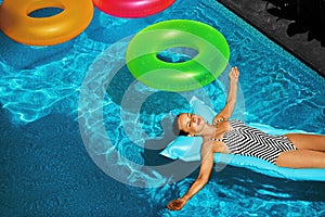 Summer Vacations. Woman Sunbathing, Floating In Swimming Pool Water