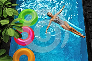 Summer Vacations. Woman Sunbathing, Floating In Swimming Pool Water