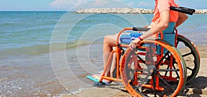 Summer Vacations of a young boy on the wheelchair on the sandy b