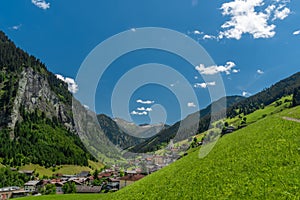 Summer valley with Grossarler Ache small river and blue cloudy sky