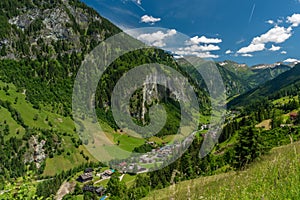 Summer valley with Grossarler Ache small river and blue cloudy sky