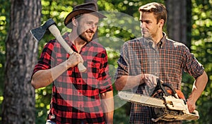 Summer vibes. deforestation. ranger or poach. man forester use saw and axe. search firewood for picnic campfire photo