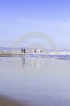 Summer vibes on the sunny autumn beach of Malvarrosa in Valencia, Spain. Vast expanses of smooth fine sand on the sea coast