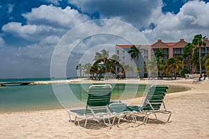 ORANJESTAD, ARUBA - October 12.2007: View on the sun beds on the sandy beach and turquoise sea in the hotel resort.