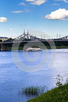 Summer view of the Volga river and cruise pleasure boat and the old Volga bridge, city of Tver, Russia.
