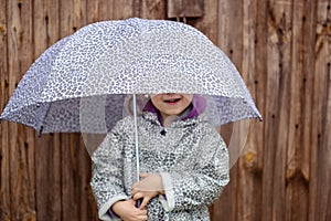 Summer walk in the rain little girl with an umbrella