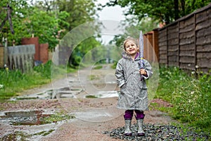 Summer walk in the rain little girl with an umbrella