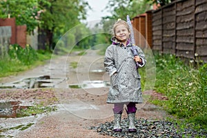 Summer walk in the rain little girl with an umbrella