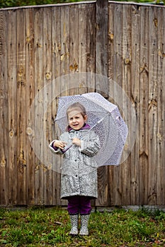 Summer walk in the rain little girl with an umbrella