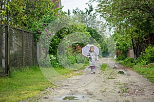 Summer walk in the rain little girl with an umbrella