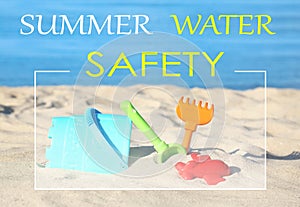 Summer water safety. Set of beach toys on sand near sea