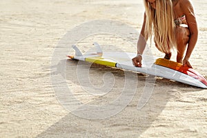 Summer Water Sports. Surfing. Beach. Woman Waxing Surfboard