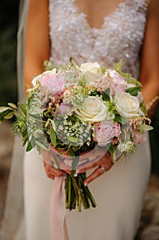 summer wedding bridal bouquet of pink and cream roses.