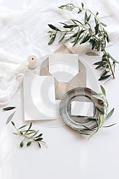 Summer wedding stationery mock-up scene. Blank greeting cards, envelope, vintage silver plate, olive branches and ribbon photo