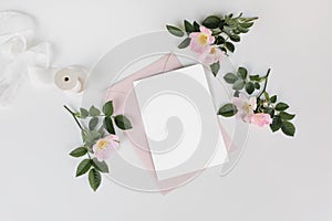 Summer wedding stationery mock-up scene with silk ribbon. Blank greeting card, invitation, pink envelope and blooming