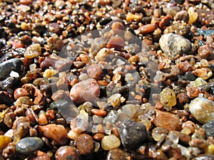 Summer wet stones and sand seaside pebble close up