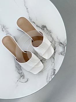 Summer white sandals. woman shoes still life