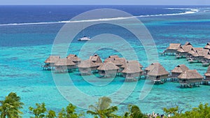 Summer wind blows past the idyllic overwater bungalows near tropical island.