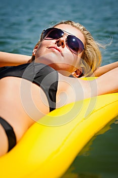 Summer woman relax on water floating mattress