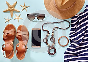 Summer women`s beach accessories for your sea holiday: straw hat, bracelets, leather sandals, sun glasses, beads