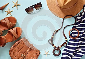 Summer women`s beach accessories for your sea holiday: straw hat, bracelets, leather sandals, sun glasses, beads