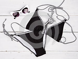 summer women& x27;s fashion with black swimsuit and white sunglasses