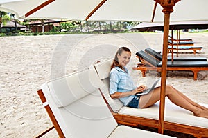 Summer Work. Woman Relaxing Using Computer On Beach. Freelance