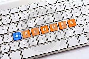 SUMMER writing on white keyboard with a aircraft sketch