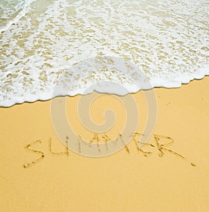 Summer written in a sandy tropical beach